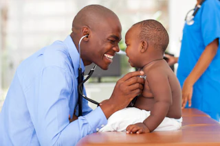 Doctor smiling with young child
