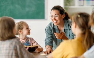 Teacher with young children at table