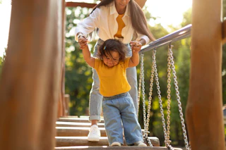 Mom and toddler on swinging bridge